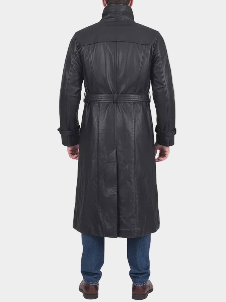 Man wearing a long black leather coat on a white background