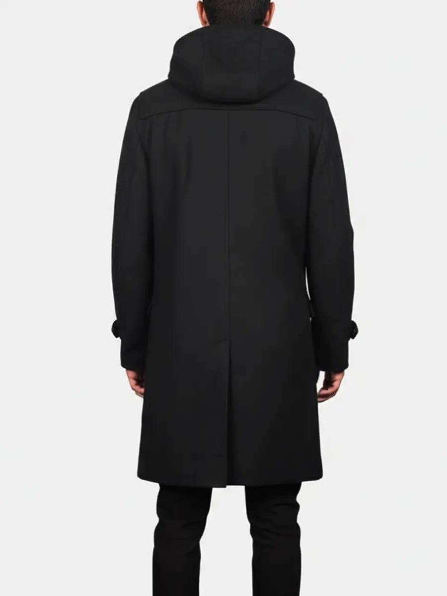 Person wearing a black coat with a hood on a white background