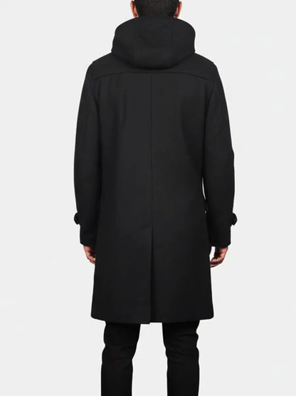 Person wearing a black coat with a hood on a white background